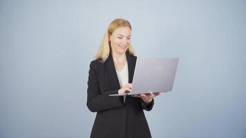 Satisfied business woman looks at laptop and approves. video