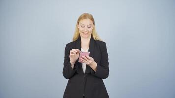 Business woman texting on the phone. Happy emoticon. video