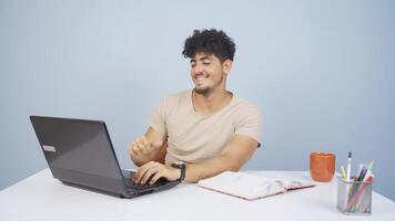 Man looking at laptop is happy and dancing. video