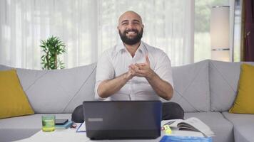 Home office worker man looking at camera clapping and getting excited. video