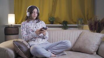 The young woman texting on the phone at night is unhappy and sad. video