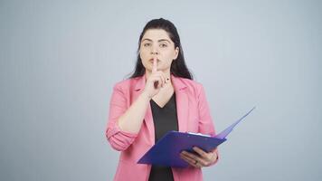 Business woman saying shut up to the camera. video