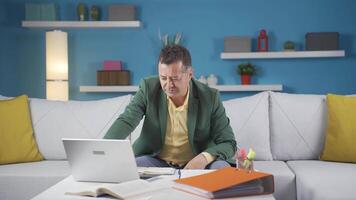 Home office worker man completes his work and relax. video