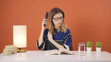 Young woman combing her hair. video