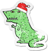retro distressed sticker of a cartoon dinosaur in christmas hat png