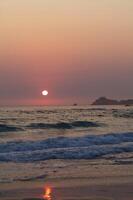 Sun Setting Off Northern California Beach Rocks And Waved photo