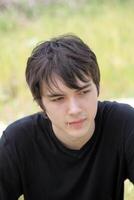 Outdoor portrait of young teen boy black shirt photo