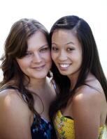 Caucasian And Asian American Women Standing Together photo