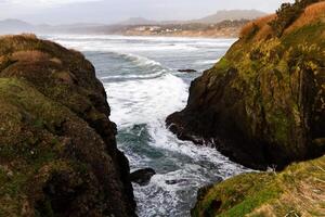 Ocean Waves Surging Between Two Headland Cliffs photo