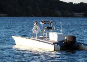 Folsom, CA, 2007 - Unmanned motor boat on floating on lake photo