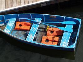 Boston, MA, 2008 - blue row boat with orange life vests at dock photo