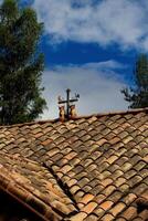 Ollantaytambo, Peru, 2015 - Roof Ornament South America Bulls Cross Moon Sun Rooster photo