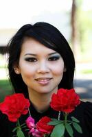 Young Asian American woman portrait with roses photo