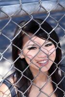 Smiling Portrait Asian American Woman Chain Fence photo