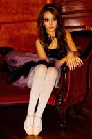 Young Caucasian Woman In Dance Outfit Sitting On Couch photo