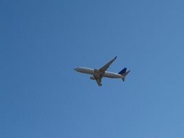 Boston, MA, 2008 - Commercial Jet Liner Climbing Into Blue Sky photo