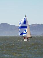 Berkeley, CA, 2007 - Sailboat on bay with spinnaker and main sail photo