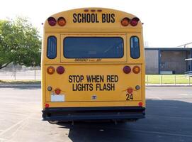 Carmichael, CA, 2006 - Back of yellow school bus in parking lot photo