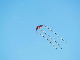 Berkeley, CA, 2007 - Colorful Rainbow Kite in blue sky photo