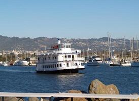 Berkeley, CA, 2007 - Large white ferry motor boat leaving marina photo