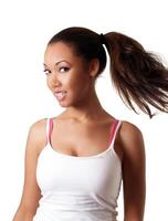 Young black woman swinging pony tail smiling photo