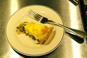 Piece Of Spinach And Mushroom Quiche On Plate photo