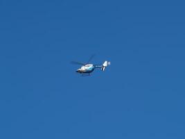 Boston, MA, 2008 - Small Medical Helicopter In Flight Against Blue Sky photo