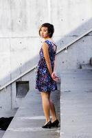 Asian American Woman In Floral Dress Looking Over Shoulder photo