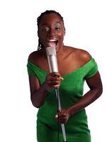 African American Woman In Green Dress Singing Into Mic photo