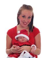 Infant Baby Sitting On Mom's Lap Wearing Christmas Outfit photo