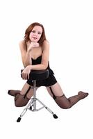 Woman in black fishnet stockings with stool photo