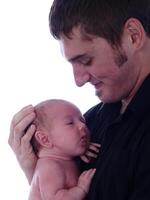 Young Caucasian Father Holding Infant Baby Chest photo