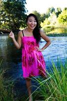 Smiling Japanese American Woman Floral Dress At River photo