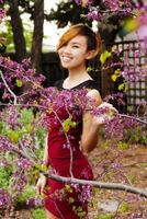 Smiling Attractive Asian American Woman Standing Outdoors photo