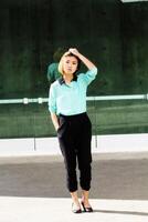 Skinny Asian American Woman Outdoors Pants And Shirt photo