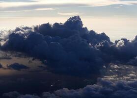 Cumulus Clouds Near Sunset From Commercial Airplane photo