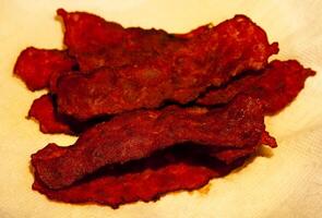 Several Strips Of Turkey Bacon On Yellow Paper Towel photo