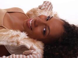 Smiling African American Woman Reclining In Jacket photo