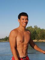 Young Smiling Man Outdoors Shirtless Swimming Trunks photo