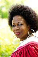 Middle-Aged African American Woman In Red Church Robes Outdoors photo