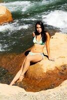 Young Caucasian Woman Sitting On Dirt Island At River photo