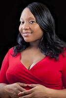 Plus-size Black Pregnant Woman in Red Dress photo