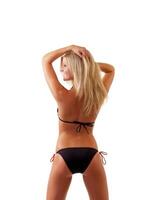 Young blond woman in black bikini from back photo