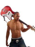 Young black man with bass guitar over shoulder photo