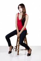 Attractive Slim Latina Woman Sitting On Stool photo