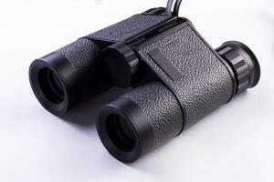 Old Black Binoculars Sitting On White Background photo