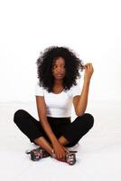 Young African American Teen Sitting Looking At Hair photo