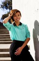 Smiling Skinny Asian American Woman Standing Outdoors photo