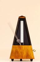 Metronome On Light Background With Blurred Arm Moving Fast photo
