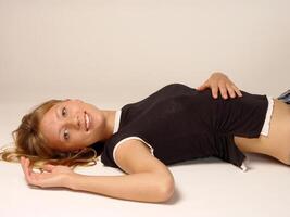 Reclining Smile Young Blond Slim Woman photo